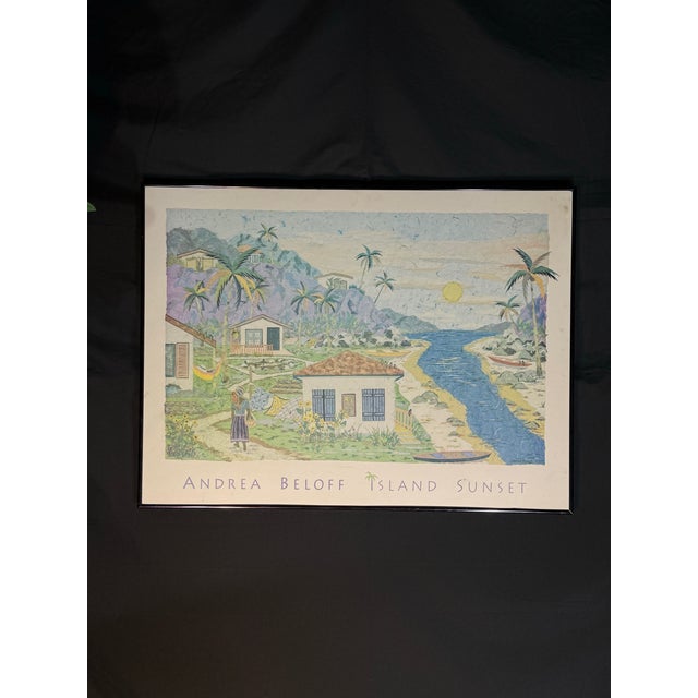 Vibrant framed art poster by Andrea Beloff titled “Island Sunset.” The piece features a tropical coastal village scene...