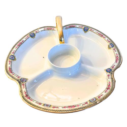This vintage Limoges porcelain divided dish, circa 1960, exudes timeless elegance with its refined craftsmanship....