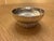 This stylish silver-plated "Babylone" bowl by Christofle, designed by Aurelie Bidermann, rests on a round braided base.and...