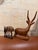 Bring a refined, worldly touch to your space with this beautifully curated pair of vintage hand-carved wooden antelope...