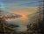 Beautiful sunset landscape of an old fishing boat, fishing shacks and the golden sun setting over a coastal inlet by...