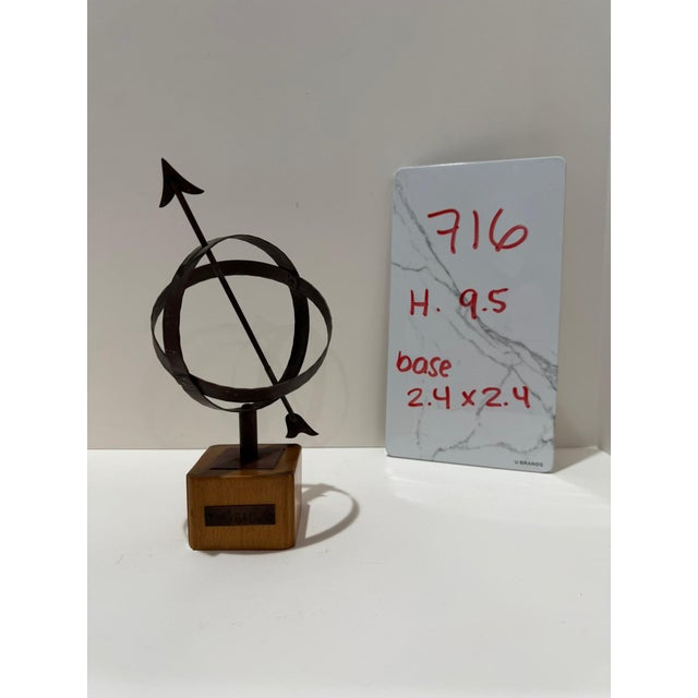Vintage Swedish modernist decorative sculpture featuring an armillary-style iron sphere with directional arrows, mounted...