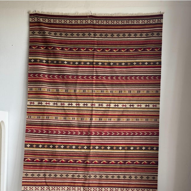 Large Indian striped rug with red, yellow, and white geometric friezes and a white base, measuring 194 x 138 cm. Weight: 4...