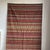 Large Indian striped rug with red, yellow, and white geometric friezes and a white base, measuring 194 x 138 cm. Weight: 4...
