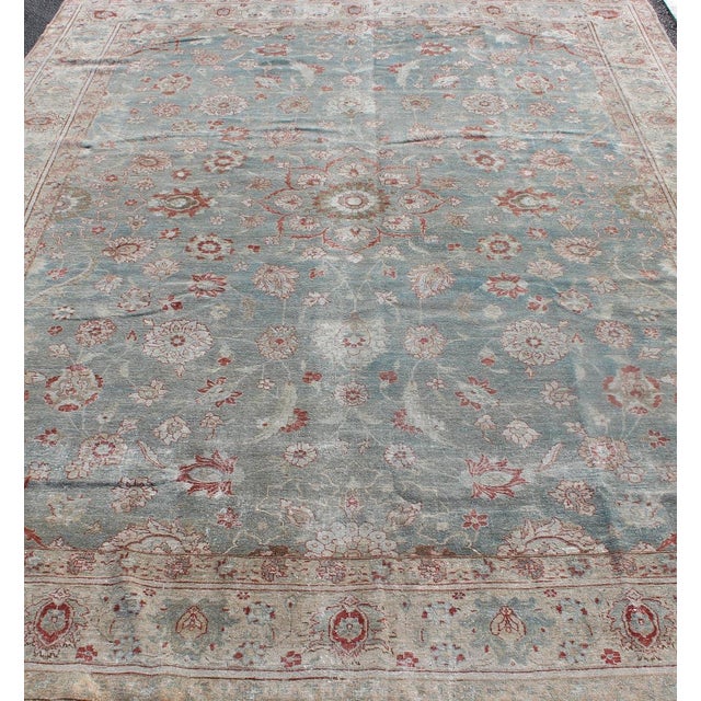 Measures: 9' x 12'5. Antique Persian Tabriz Rug with Allover Floral Pattern in Soft Blue, Cream & Red. Keivan Woven Arts /...