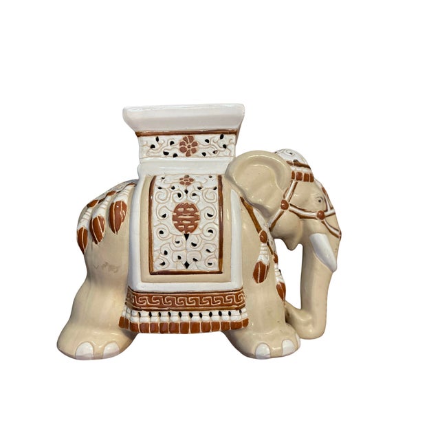 Vintage ceramic brown and beige elephant garden stool. Estimated to be from the 1970s. Contains cracks and a hole in the...