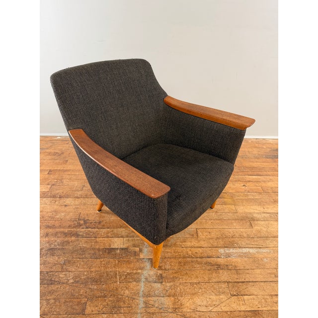 Mid century modern chair designed by Torbjorn Afdal for Stranda Industri. The chair features sharp teakwood arm rests that...
