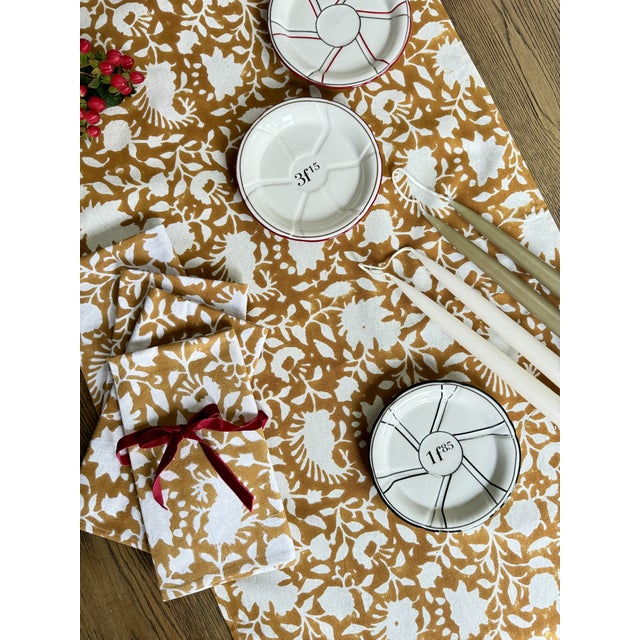 Hand block printed table runner featuring a classic floral design in an elegant yellow ochre against white cotton. 17" x...