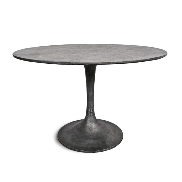 Modern indoor outdoor round metal pedestal dining table. Each varies slightly with details on finish.