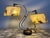 Striking 1950s Atomic Age dual-arm table lamp attributed to the Majestic Lamp Company. The sculptural brass-tone metal...