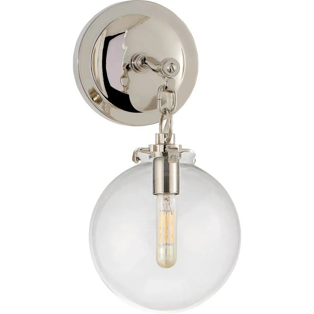 Katie Small Globe Sconce in Polished Nickel with Clear Glass Designer: Thomas O'Brien Height: 12.5" Extension: 9.75"...