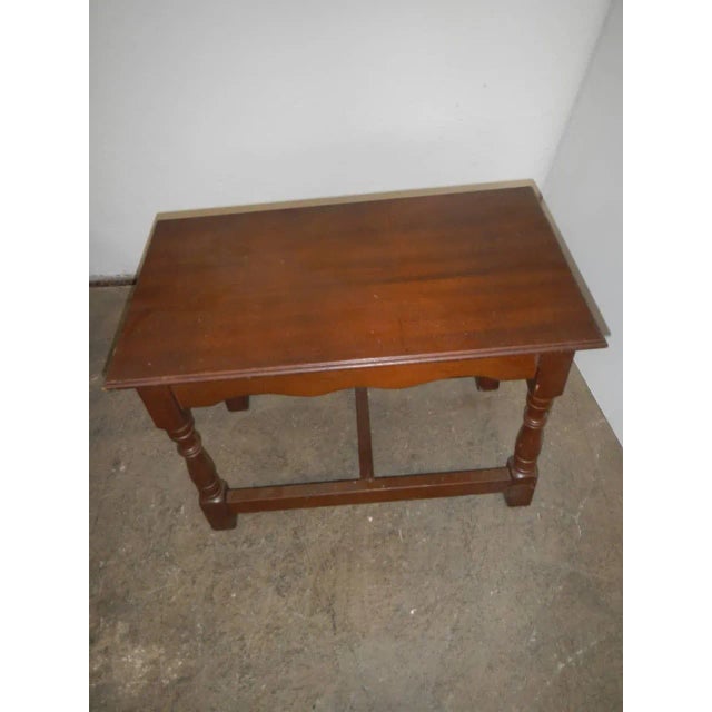 Particular coffee table with side stool holder.