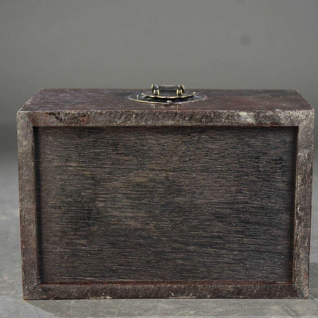 This beautifully crafted box features intricate relief carvings on the lid, depicting a traditional Chinese dragon motif...