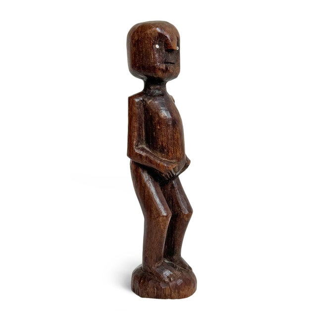An evocative Kaguru fertility figure from central-eastern Tanzania, hand-carved in dense hardwood and presenting the...