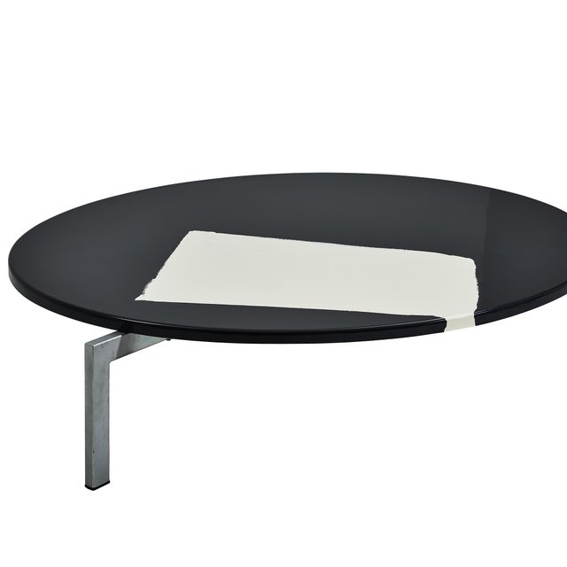 The Kimo table, designed by Marco Bellomo and Antonio Brizzi in 2003 and manufactured by Dilmos, Italy, features a three-...