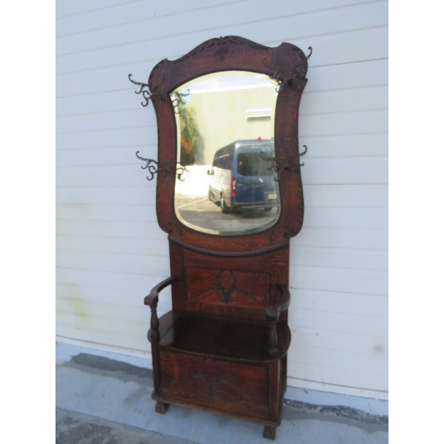 This highly elegant Hall Tree is made of wood, solid wood, oak, tiger oak, mirror, and metal. This great Hall Tree was...
