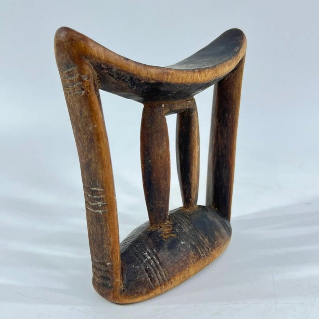 Ethiopian headrests come in various forms. They range from simple to elaborately carved artifacts. They have abstract...