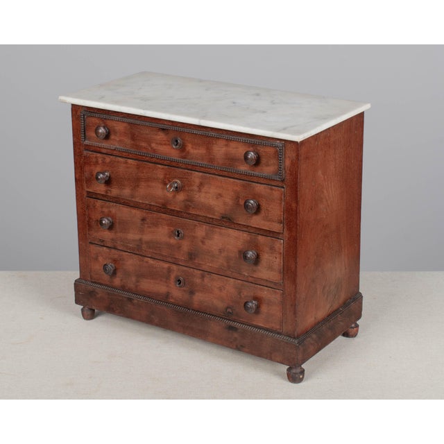 A 19th century Louis Philippe miniature sample commode made of mahogany with French polish finish. Four dovetailed drawers...