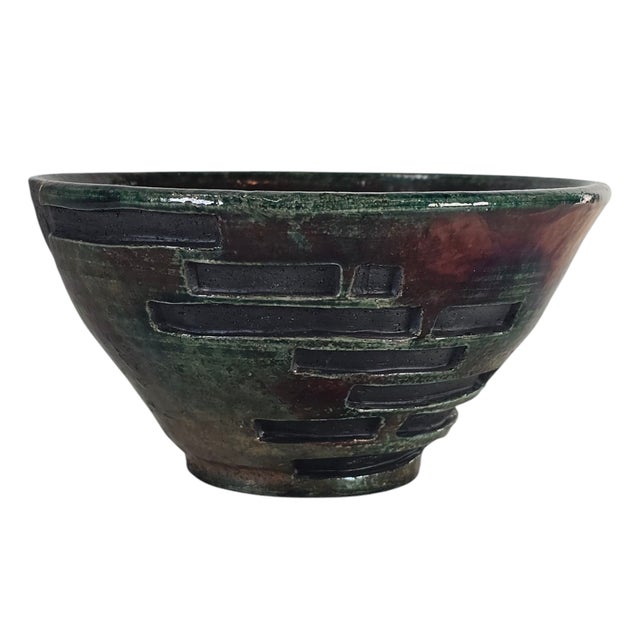 The bowl gleamed, catching light like a river at dusk. Iridescent green and purple, shifting, changing—never still. A...