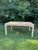 Vintage lacquered grasscloth dining table in a natural straw color. Beautiful parsons-style table comes with two leaves....