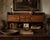 A beautiful antique wood cabinet with a long, low profile, petite drawers, paneled cupboards, and original white porcelain...