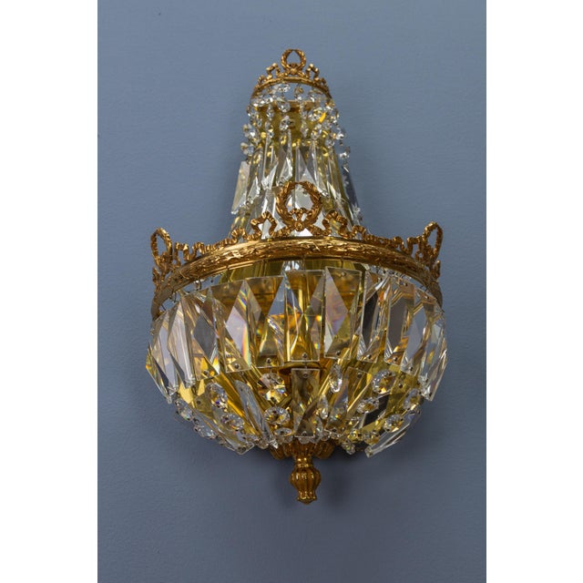 A splendid Empire-style sconce by Palwa, Germany, 1960s. Gilt brass frame adorned with crystal glass beads and prisms,...