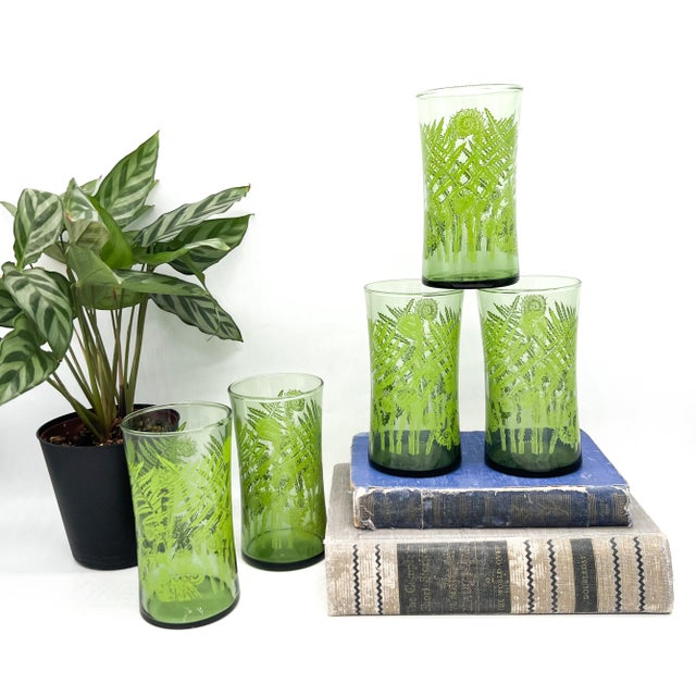 Bring a touch of botanical charm to your table with this set of five vintage highball glasses featuring a vibrant green...