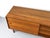 Perfectly proportioned, low teak sideboard with three drawers and a sliding door with a round recessed handle. One shelf...