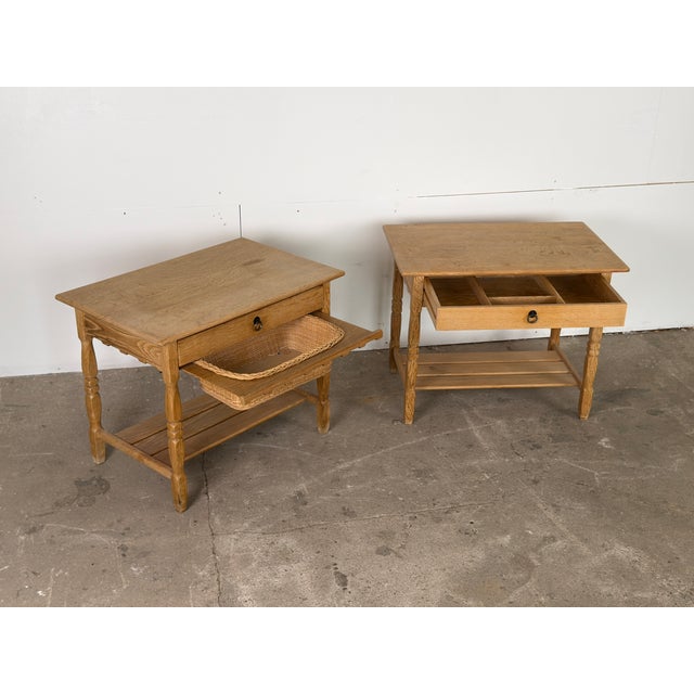 A handsome pair of Scandinavian mid-century oak nightstands or side tables designed by Henning Kjærnulf, dating from the...