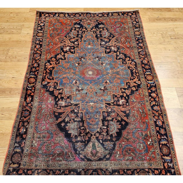 "A striking vintage Persian Farahan area rug, exquisitely woven with a refined botanical composition of exceptional visual...