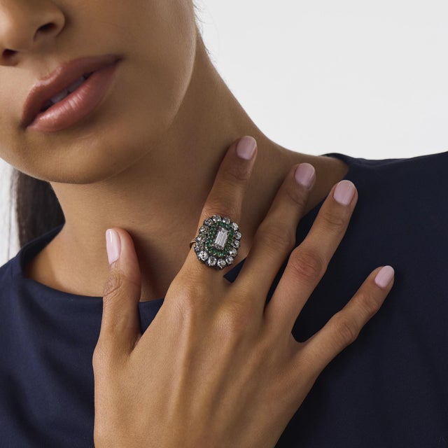 This extraordinary Victorian diamond and emerald cluster ring is a striking antique design from the 1900’s, centered by a...