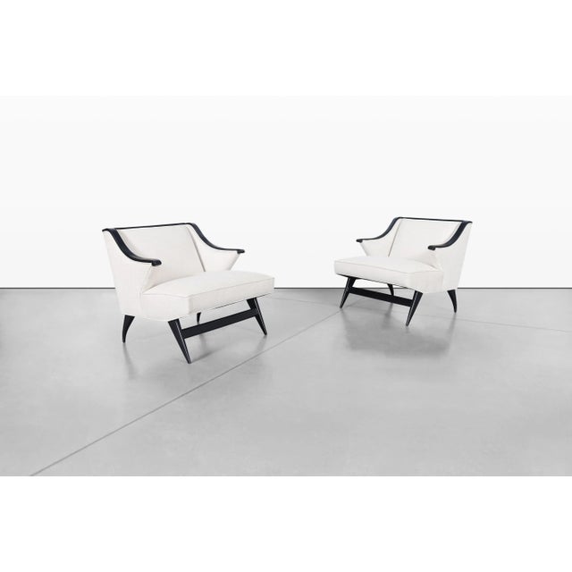 Pair of mid-century modern Italian lounge chairs, 1950s. Expertly crafted in Italy during the 1950s, this striking pair...