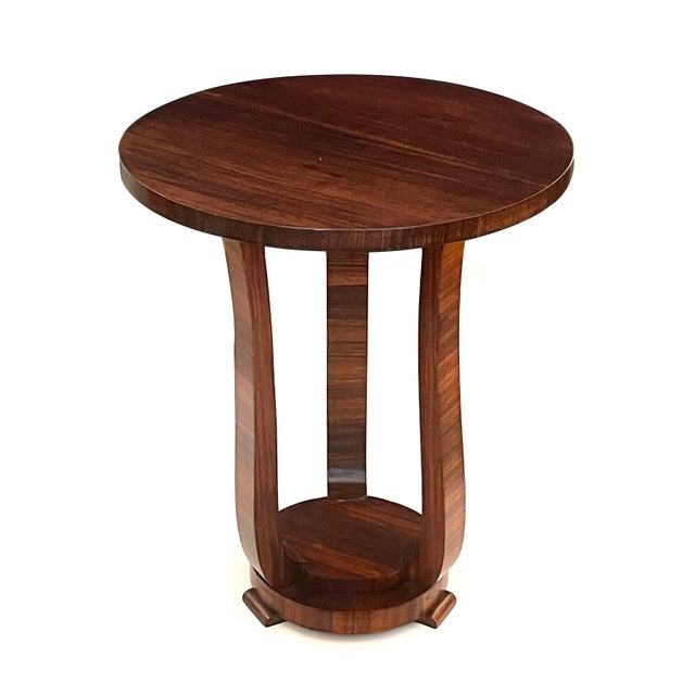 the period Art Deco occasional table featuring a well-figured circular top raised on scrolled upright supports with...
