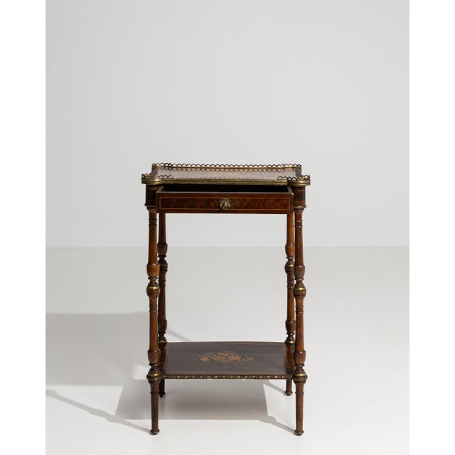 A charming Napoleon III side table featuring a two-tier design that enhances both functionality and visual appeal. The...