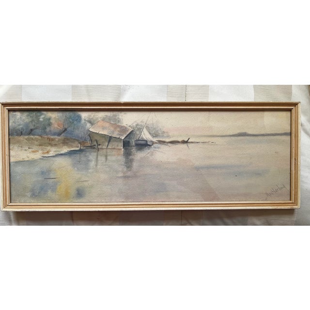 Mae Harding (American, 20th C) watercolor painting on paper depicting a lake scene with old boat house in a soft and...