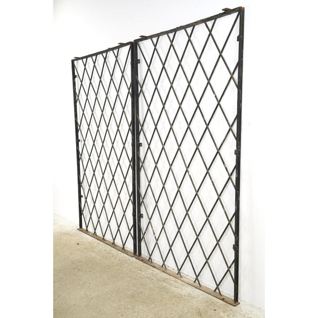 Industrial style black wrought iron security panels made in a diamond pattern with a rectangular frame. These panels are...