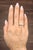 A stunning natural 1.07-carat round diamond takes center stage, exhibiting its pristine white hue. Flanked by...