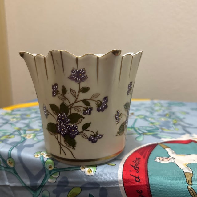 Add a touch of classic elegance to your home with this vintage-style porcelain vase. This piece features a charming, hand-...