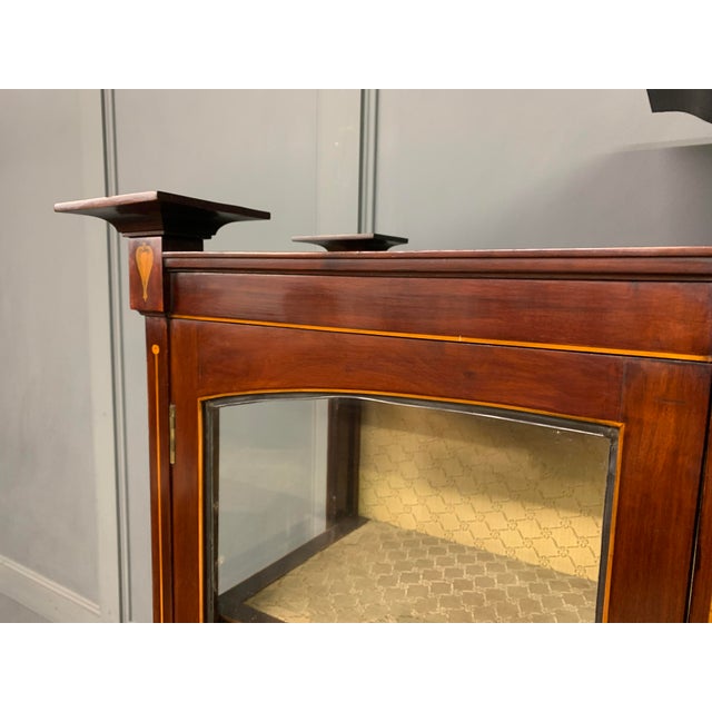 A splendid Arts and Crafts period display cabinet in the manner of Wylie and Lochhead. Of very good construction in solid...