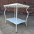 Rare and unusual Salterini outdoor metal side table with brass accents and white glass shelves. Both table tops can be...