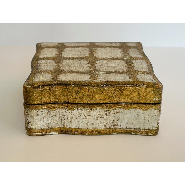 Wooden hinged box with white and gold paint and etched details. This box is perfect for small trinkets, keepsakes, and...