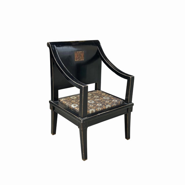 This is an oriental modernized armchair with a black lacquer surface. The seat back is in a scroll shape and a Chinese...
