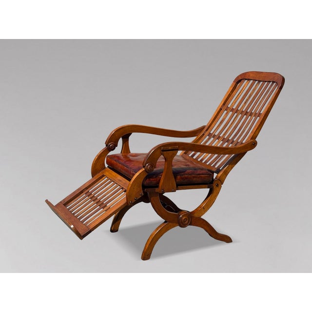 Stunning Pair of 19th-Century Victorian Walnut Colonial Reclining Armchairs, circa 1860 This rare and exceptional pair of...