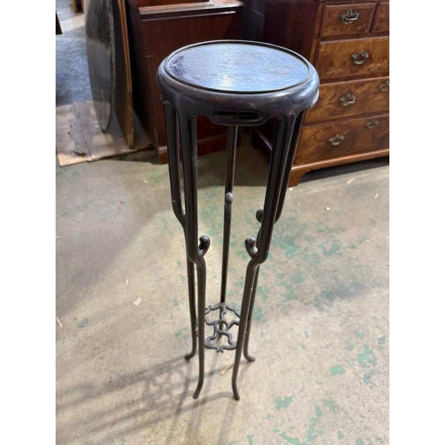 A graceful early 20th-century Art Nouveau plant stand crafted entirely from wood. This tall and slender piece features...