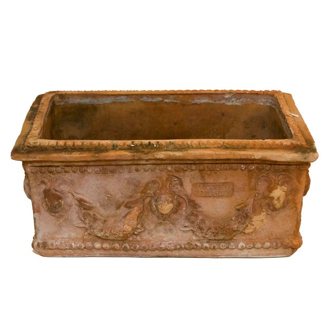 An Antique Neapolitan terra cotta planter adorned with festoons and lion heads. This attractive planter would make a...