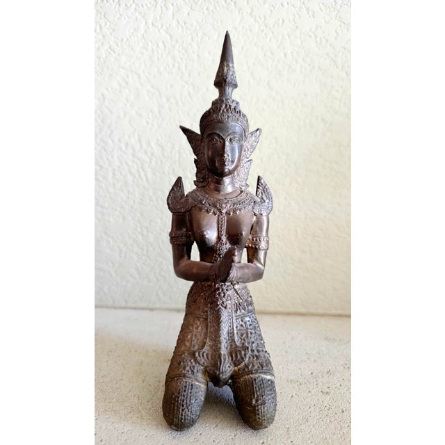 Early 20th Century Thai Bronze Thepphanom Devata Statue – Kneeling Celestial Guardian, 9” Description: An elegant early...
