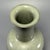 Elegant Chinese celadon porcelain long‑neck vase with a graceful flared rim and well‑proportioned full body. It is...