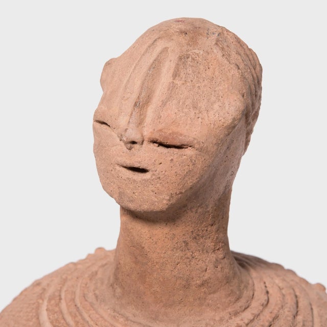 Most examples of Bura spirit vessels, or Bura bells, are phallic columns of terra cotta incised with complex geometric...