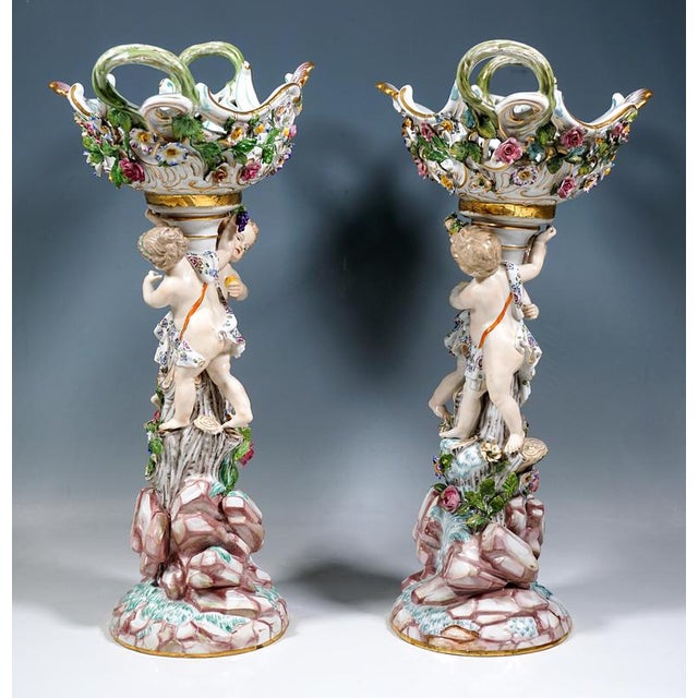 The pair of centrepieces was designed by Leuteritz using old molds in the Rococo style: Towering rocks from which a tree...