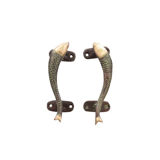 A pair of fish shaped door handles or cabinet pulls made of brass with a green finish. Cast with delicate scales and...
